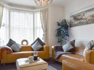 a living room with two couches and a christmas tree at Driftwood in Scarborough