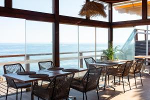 a restaurant with tables and chairs and a view of the ocean at Eden Villas & Apartments in Albufeira +128 photos