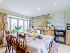 a kitchen with a table with a white table cloth at Seaton Court - Uk31955 in Staithes