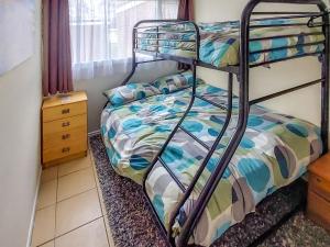 En eller flere senge i et værelse på Sandy Belle