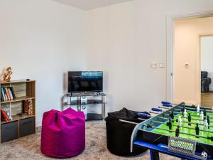 a living room with a foosball table and a table at Chestnuts in Burgh by Sands