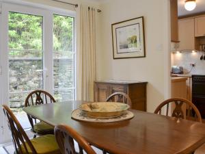 a dining room with a table with a bowl on it at Meadowcroft Cottage in Bowness-on-Windermere