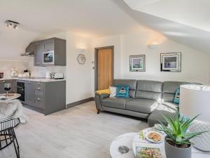 a living room with a couch and a kitchen at Sweet Briar in Sibsey