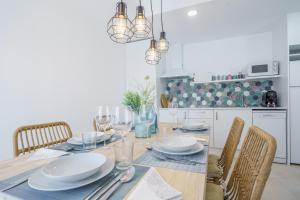 a dining room with a table and chairs at Bamblue Boutique Apartments in Pineda de Mar