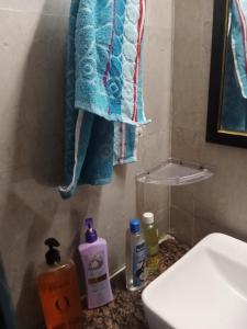 un bagno con un asciugamano blu appeso a una parete di Sunworld Arista T10 ,906 a Noida