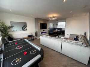 a living room with a couch and a table at Seaview House in Thornton