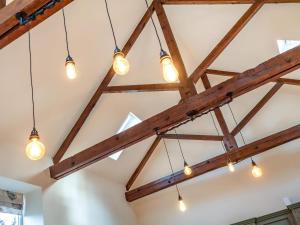a group of lights hanging from the ceiling of a room at Coach House in Rowston