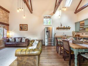 a kitchen and living room with a table and a refrigerator at Coach House in Rowston
