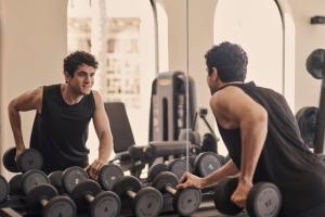 two men working out in a gym with weights at The Chedi El Gouna in Hurghada