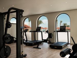 a gym with several treadmills and elliptical machines at The Chedi El Gouna in Hurghada