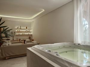 a bathroom with a bath tub in a room at The Chedi El Gouna in Hurghada