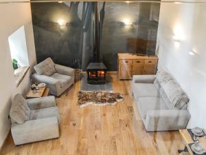 a living room with two couches and a fireplace at Cullew Bothy in Pearsie