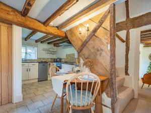 a kitchen and dining room with a table and chairs at The Cottage in Warborough