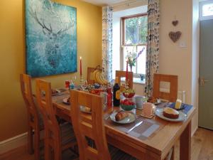 a dining room with a wooden table with food on it at Newburgh C Listed Townhouse in Newburgh