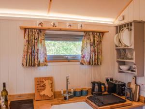a kitchen with a sink and a window at Little Willows in Potterne