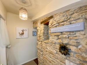 a room with a stone wall with a sign on it at The Nest in Hawthorn