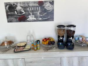 a shelf with cups of coffee and fruit on it at B&B Scirocco e Tramontana in Gallipoli