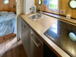 a kitchen with a sink and a bed in a room at The Prince - Uk42204 in Clachan of Glendaruel +20 photos