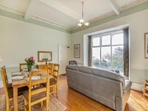 a living room with a couch and a table at Sea And Sands in Barmouth