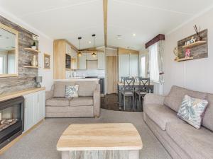 a living room with a couch and a fireplace at The Bordeux in Dornoch