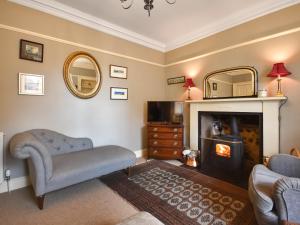 a living room with a couch and a fireplace at Rennie House in East Linton