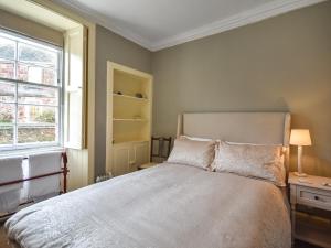 a bedroom with a large bed and a window at Rennie House in East Linton +11 photos