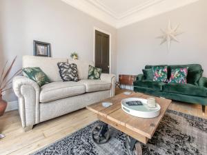 a living room with a couch and a coffee table at Lanner Moon in Carnbrea