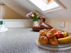 a plate of fruit and croissants on a counter at Lavrean Farm in St Austell +13 photos
