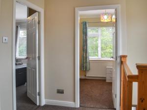 a hallway with a door leading to a bathroom at Oceans 44 in Sewerby
