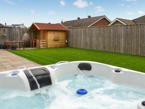 a hot tub in a backyard with water at Oceans 44 in Sewerby