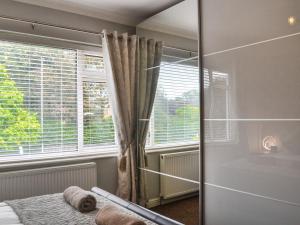 a bedroom with a bed and a large window at Oceans 44 in Sewerby