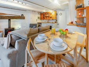a living room with a table and a couch at Fishermans Cottage in St Ives +22 photos