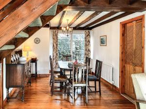 a dining room with a table and chairs at Butterfield Cottage in Tideswell