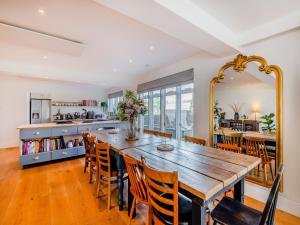 a dining room with a large wooden table and chairs at Denmark House in Burham