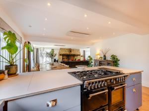 an open kitchen with a stove and a living room at Denmark House in Burham +30 photos