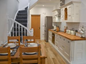 a kitchen with a table and a dining room at Norfolk Headquarters in Fakenham