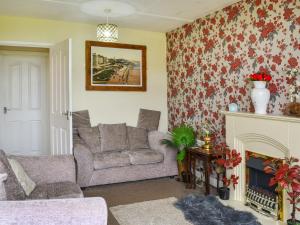 a living room with a couch and a fireplace at Yeolde Woodern Country View Seashak - Uk46596 in Bridlington