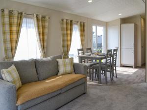 a living room with a couch and a table at Lodge 46 - Uk49669 in Bridlington