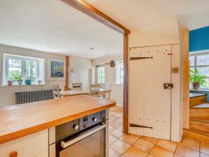an open kitchen and dining room with a table at Brookend Cottage - Uk49705 in Barton