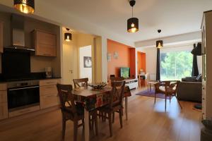 a kitchen and dining room with a table and chairs at A5 - Résidence La Montille in Mont-Dore