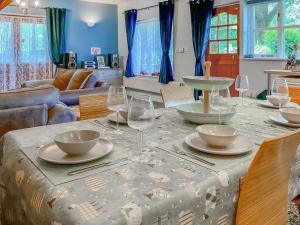 a dining room table with wine glasses on it at Court Place in Misterton +20 photos