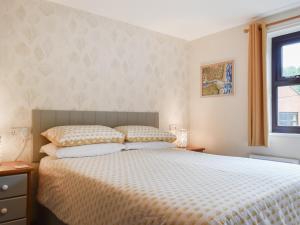 a bedroom with a bed and a window at Hey Ho Cottage in Whitby +17 photos