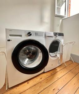 a washing machine and a dryer in a room at Maison Blanc de blanc - Guest Room in a Family Home in Le Mesnil-sur-Oger