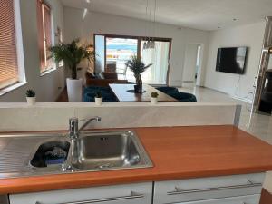 a kitchen with a sink and a living room at Vacation home Oxy in Ferlach
