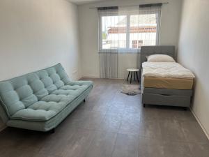 a living room with a couch and a bed at Vacation home Oxy in Ferlach