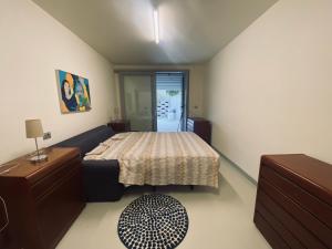a small bedroom with a bed and a table at Villa immersa nei campi in Casal Fiumanese +55 photos