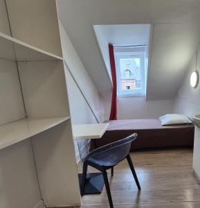 a small room with a bed and a desk and a chair at Budget Hôtel Weber - Strasbourg Centre Gare in Strasbourg +53 photos