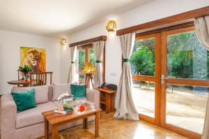 a living room with a couch and a sliding glass door at White Paradise Zanzibar in Pongwe +63 photos