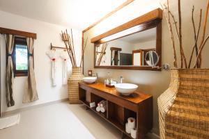 a bathroom with two sinks and a mirror at White Paradise Zanzibar in Pongwe