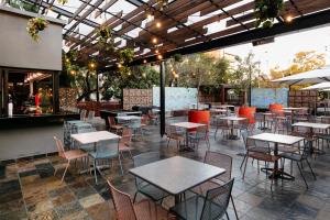 an outdoor patio with tables and chairs and a restaurant at Hotel 224 & Apartments in Pretoria